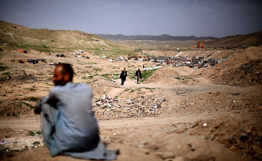 <p>A man sits near the entrance to Kamar Kulagh, just outside Herat and near the border with Iran. The wars and upheavals in Afghanistan over the past three decades have contributed to the widespread use of drugs.</p><p></p>