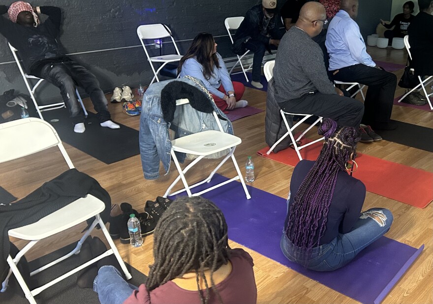 Individuals begin to sit on the floor for the next exercise