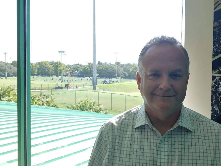 New USF Vice President of Athletics Michael Kelly stands in his office on the Tampa campus Tuesday while the football team practices outside.