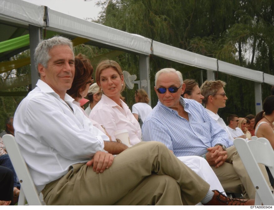 Jeffrey Epstein, Abigail Wexner, and Leslie Wexner seated together at an outdoor event.