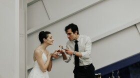 young couple feeding cake to each other