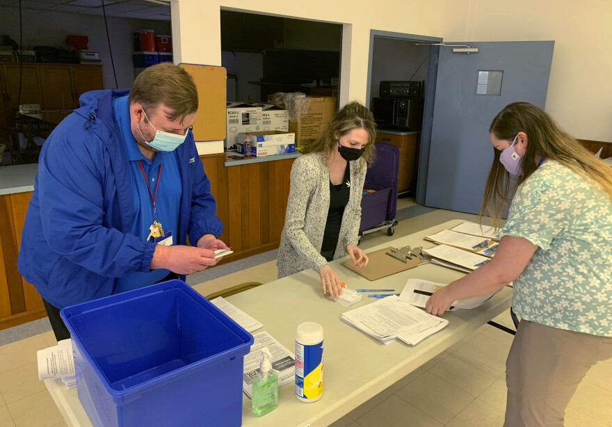 Holmes County health department staff members (from left) Michael Derr, Jennifer Talkington and Abbie Benton prepare materials for a COVID-19 vaccine clinic inside St. Peter's Catholic Church in Millersburg, Ohio, on April 8.