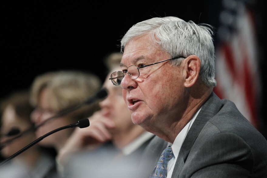 Close-up of Bob Graham speaking into a microphone during a meeting