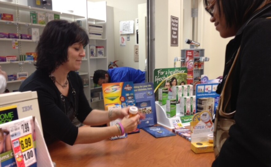 Heidi Polek, manager of pharmacy operations at Tops, shows off new Rx Timer Cap