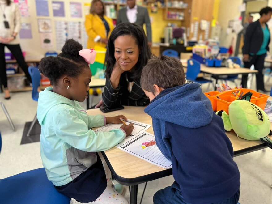 Crystal Hill, CMS superintendent, sitting at a table with children