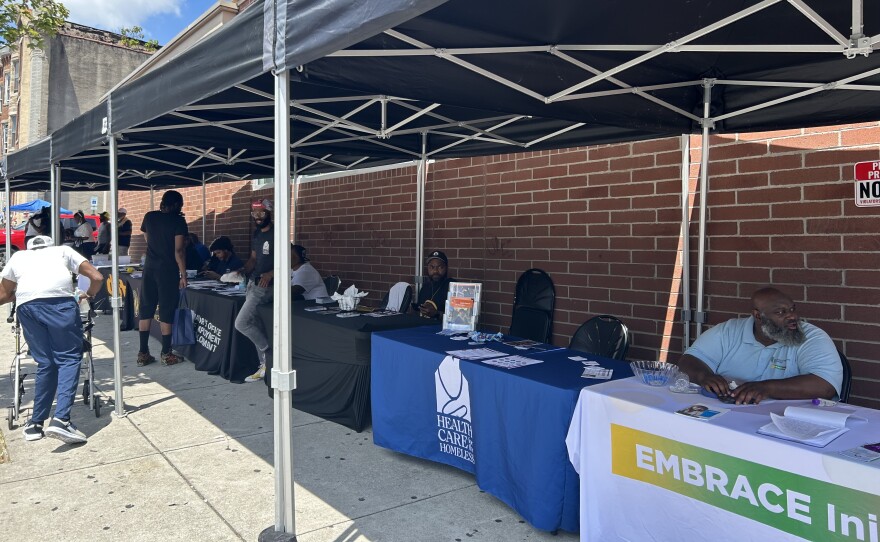 Nonprofits and city services set up in the Penn North neighborhood for a resource fair on Monday, July 28, 2025. Photo by Scott Maucione/WYPR.