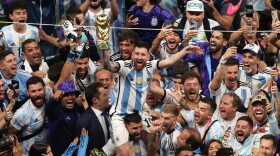 Lionel Messi of Argentina celebrates with the world cup trophy following his sides victory  during the FIFA World Cup Qatar 2022 Final match between Argentina and France at Lusail Stadium on Dec. 18, 2022 in Lusail City, Qatar. (Alex Pantling/Getty Images)