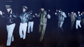 The crew from the American Navy ship USS Pueblo being taken as prisoners of war.