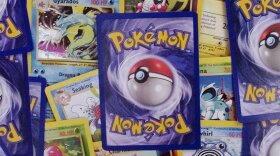 A selection of Pokemon trading cards are displayed in a pile