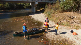 Volunteers pulling discarded tires from the Little Miami River.