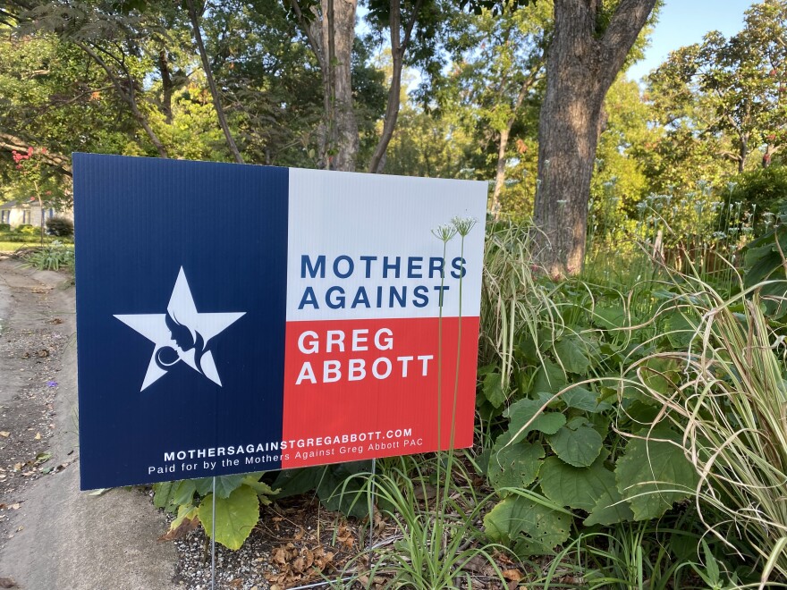 A sign of Mothers Against Greg Abbott outside a home in East Dallas.