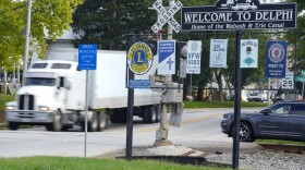 A semi-truck crosses a railroad crossing on the edge of town in Delphi, Ind., Tuesday, Oct. 1, 2024.