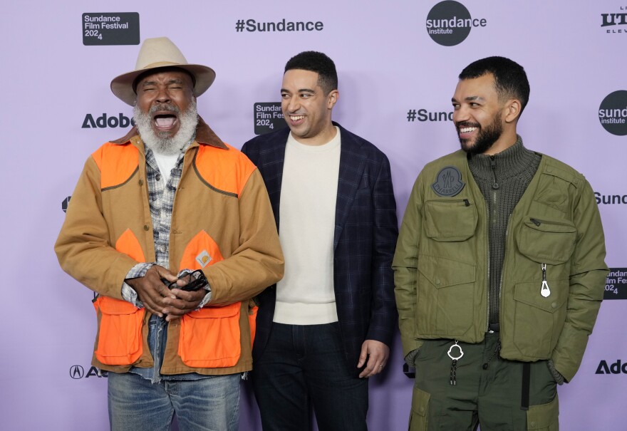 Kobi Libii, center, writer/director/producer of "The American Society of Magical Negroes," poses with cast members David Alan Grier, left, and Justice Smith at the premiere of the film at Eccles Theatre during the Sundance Film Festival, Friday, Jan. 19, 2024, in Park City, Utah.