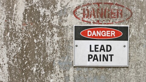 This stock photograph shows a sign that warns against the presence of lead paint.
