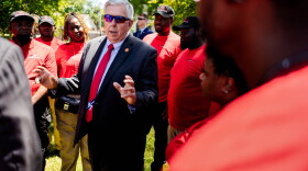 Missouri Gov. Mike Parson talks to members of the Urban League's "Serving Our Streets" initiative on Tuesday, June 28, 2022, while visiting north St. Louis as part of a legislative wins tour. Parson allocated $1 million for the initiative in 2020.