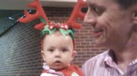 Jerry Squier made sure his daughter, 8-month-old Brooke, was dressed for the occasion last night at the Kentucky Christmas Chorus.
