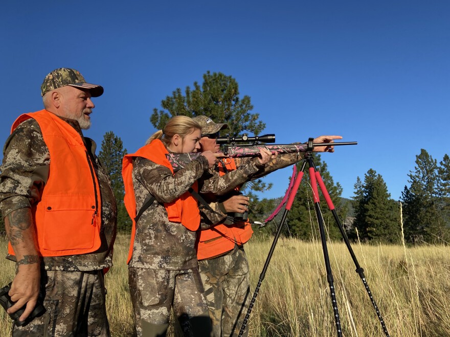 Julianne Hinkle, 16 of Yakima, learns to set up a shot. Mentors Bill Hinkle (left) and Ryan Janke tell her not to shoot because the deer had a young fawn with it.