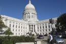 A man walks by the Wisconsin Capitol, Oct. 10, 2012, in Madison, Wis.