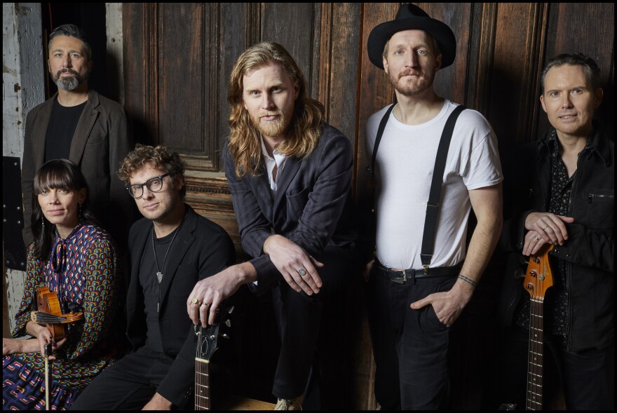 The members of the Lumineers, an American folk rock band, posing for a publicity photo.