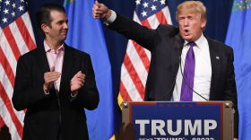 Donald Trump Jr. (left) looks on as his father, then-Republican presidential candidate Donald Trump, waves after speaking at a caucus night watch party at the Treasure Island Hotel & Casino on February 23, 2016 in Las Vegas, Nev. (Ethan Miller/Getty Images)