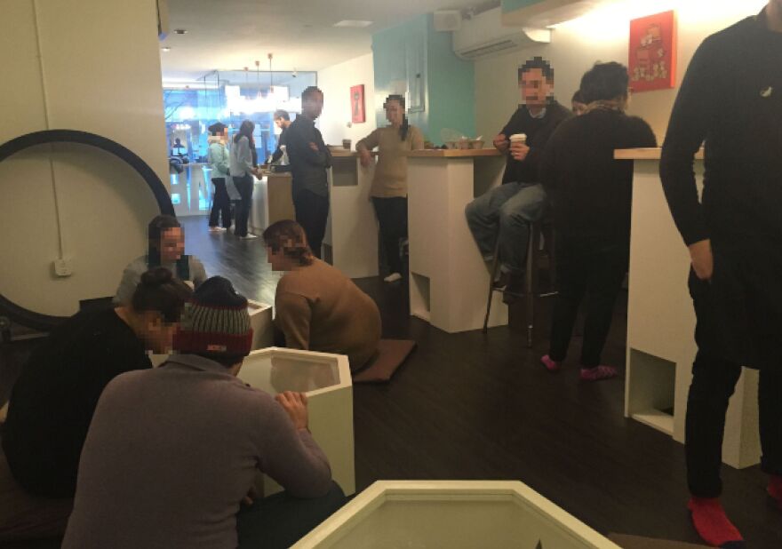 Image has been altered to protect the identities of people who choose to go to a cat cafe.