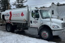 An Irving Oil truck is parked on a snowy street