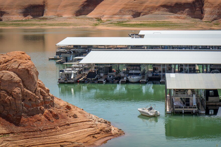 A boat navigates away from the main houseboat slip area at Bullfrog Marina in the final days before it’s moved to Halls Crossing, April 28, 2026.