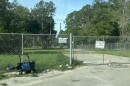 'No trespassing' and 'No public camping' signs on a fence in Gainesville.