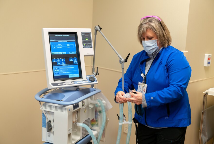 Respiratory therapist Mary Graham sets up a ventilator at the height of the pandemic at the facility. Three critical patients were on those machines — while the hospital had only two dedicated ICU rooms. Ordinarily, the hospital would be able to transfer its worst cases to larger facilities in the area, but COVID-19 had pushed those over capacity too.