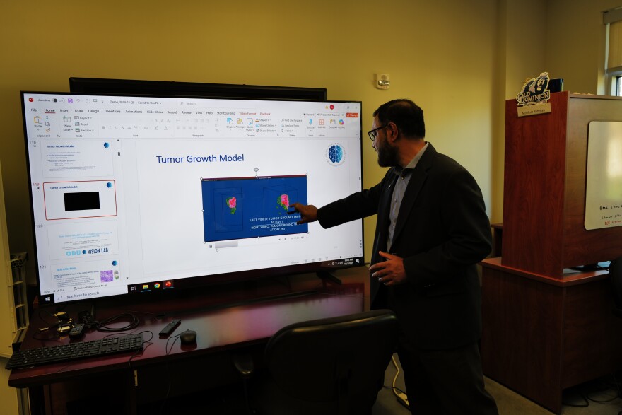Khan Iftekharuddin demonstrates an AI-driven tumor growth model in his lab at Old Dominion University.