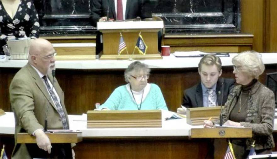 Reps. Tim Brown (R-Crawfordsville) and Sue Errington (D-Muncie) discuss the to-be-appointed Muncie school board on the House floor Wednesday evening