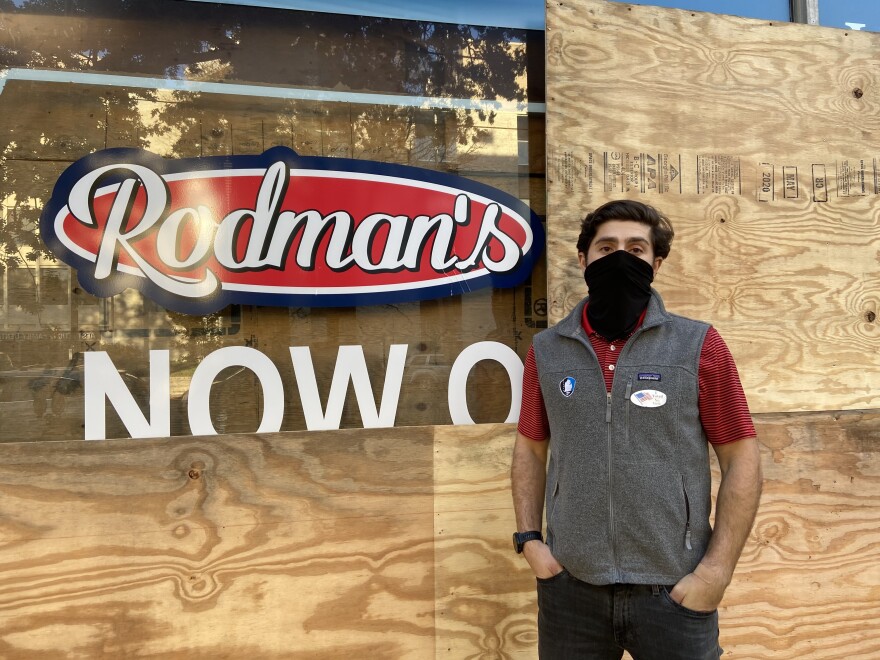 Nolan Rodman stands in front of the boarded-up Rodman's Food and Drug in Washington. Cities across the country are preparing for possible protests, civil unrest and violence regardless of the election's outcome.