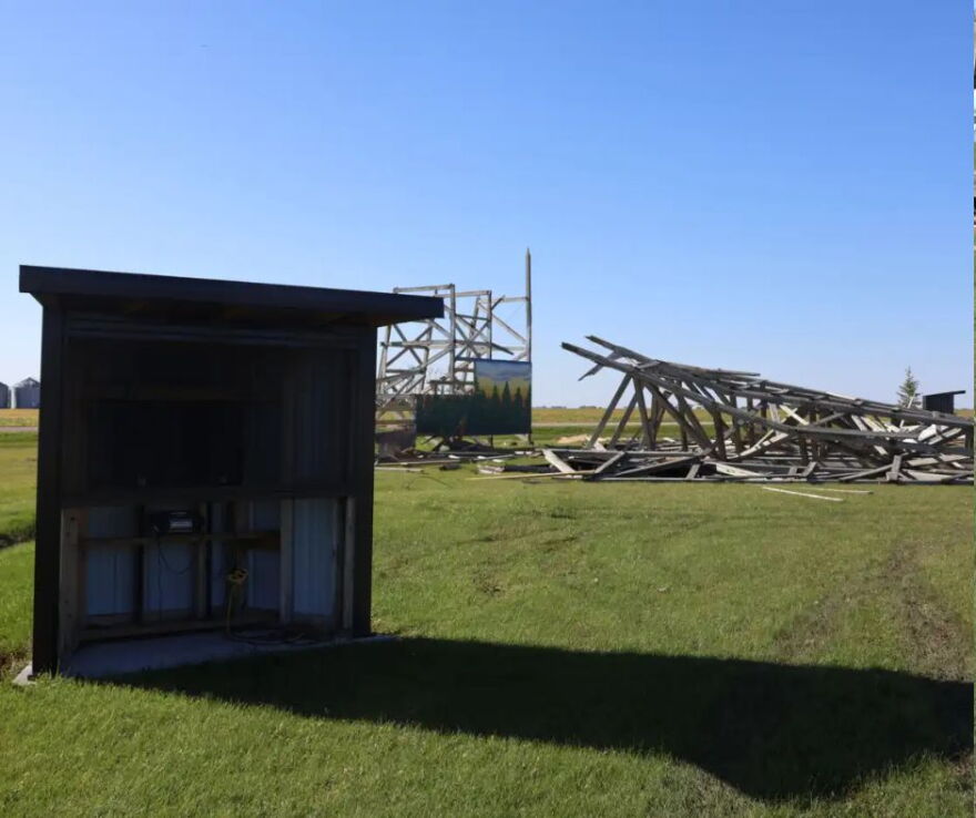 A speaker sound system is set up beside a destroyed Sky-Vu screen. Two other speaker sets are crushed beneath the wreckage | MPR News