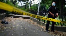 A police officer stands near the scene of a fatal afternoon shooting in the Brooklyn borough of New York City in 2020.