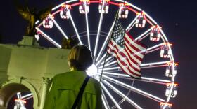 A person carries an American flag at the Great American State Fair, Tuesday, June 30, 2026, on the National Mall in Washington, D.C. (Julia Demaree Nikhinson/AP)