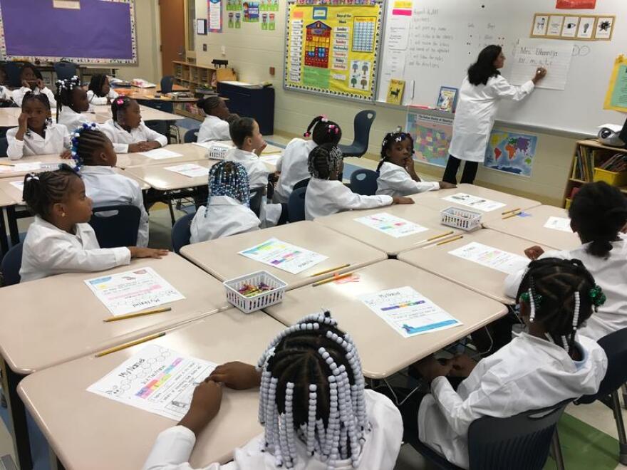 As part of a new program, Bond Hill Academy, which focuses on math and science, requires kids to wear lab coats.