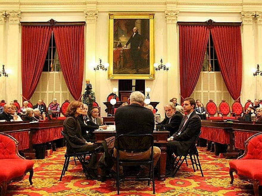 A joint meeting of the Senate Judiciary and Health committees listens to testimony on the House floor at the State House.