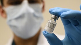 Army Spc. Angel Laureano holds a vial of the COVID-19 vaccine, Walter Reed National Military Medical Center, Bethesda, Md., Dec. 14, 2020. (DoD photo by Lisa Ferdinando)