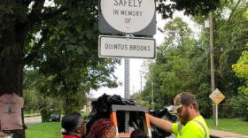 The family of Quentus Brooks helps install the city's first official roadside memorial.