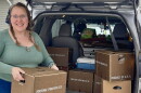Kristine Jonas, manager of the Virginia Farmers Market Hub, loads boxes of produce for delivery.