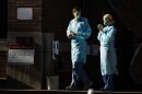 Healthcare workers stand by at a COVID-19 temporary testing site at Abington Hospital in Abington, Pa., Wednesday, March 18, 2020.