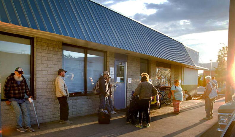 People stand outside the Corpus Christi House.