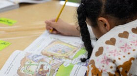A student at Tulsa Public Schools writes in a workbook during English Language Arts instruction.