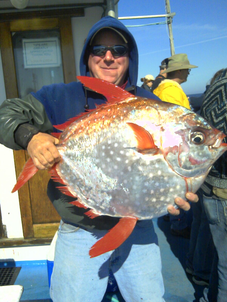 Shannon Hunter of Newport holds an opah caught last summer on the charter vessel "Misty." Opah is tasty fish normally found in Hawaiian waters.