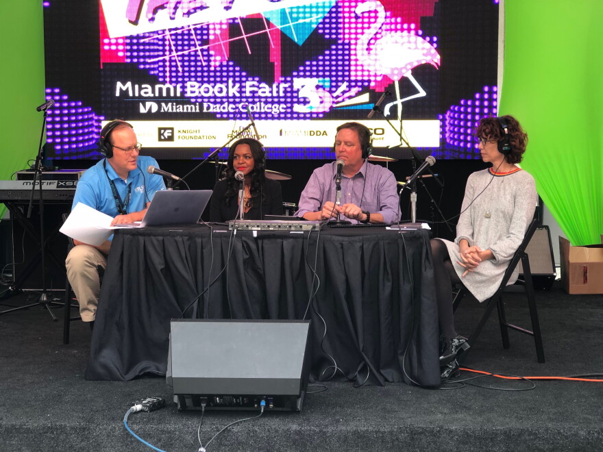 From left to right, WLRN's Tom Hudson hosts a Miami Book Fair panel: romance novelist Nadine Gonzalez, AP reporter Curt Anderson and essayist Dawn Davies.