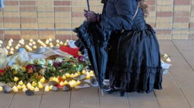 A UNT music student attends a memorial Monday staged for the canceled exhibit by Victor "Marka27" Quiñonez, outside the UNT College of Visual Arts and Design Gallery. She and others wore all black to mourn the loss of free speech.