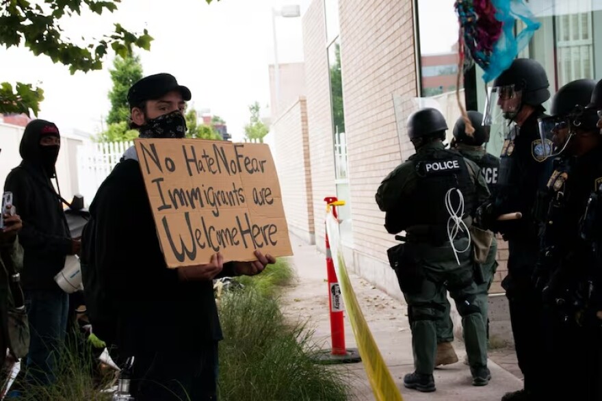 FILE-Federal law enforcement officers hold a police line at the Portland ICE building on Southwest Macadam Avenue, June 28, 2018. Oregon's sanctuary law prevents state law enforcement from carrying out federal immigration law.