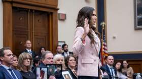 Bryon Norm, left, watches as his wife, Homeland Security Secretary Kristi Noem, as she is sworn in before testifying in front of a House Judiciary Committee hearing on the oversight of the Department of Homeland Security, Wednesday, March 4, 2026 in Washington. (AP Photo/Kevin Wolf)