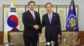 In this photo provided by South Korean Prime Minister Office, South Korean Prime Minister Han Duck-soo, right, shakes hands with Florida Gov. Ron DeSantis during a meeting at the government complex in Seoul, South Korea, Wednesday, April 26, 2023. (South Korean Prime Minister Office via AP)