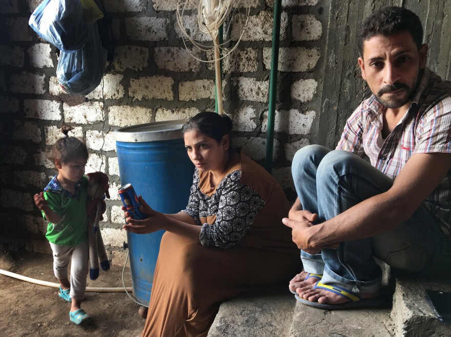 Ashraf Attiya sits with his wife, Fifi, and daughter Sandy. The Christian family was expelled from their village after Attiya was accused of being involved with a married Muslim woman. A mob stripped and dragged his mother through the streets and burned down their house.